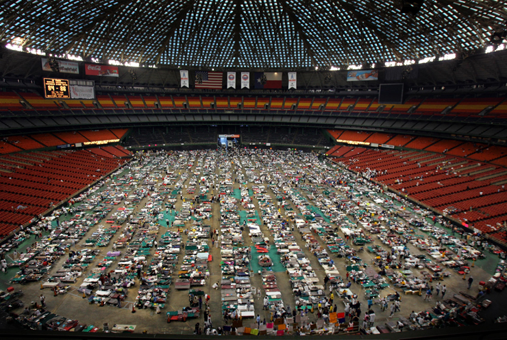 Victims of Hurricane Katrina stay at the Astrodome stadium where 16,000 evacuees are receiving food and shelter in Houston, Texas September 4, 2005. The arena is being used as an intake facility where medical care is provided and evacuees of Hurricane Katrina are evaluated for assignment to other facilities. Pictures of the Year 2005 REUTERS/Carlos Barria CB/SA - RTRMLYO